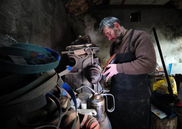 Shoemaker Dan Nelson pictured in his workshop. Picture by Simon Hulme.