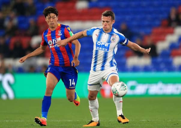 HELLO AGAIN: Crystal Palace's Lee Chung-yong and Huddersfield Town's Jonathan Hogg battle for the ball during the Carabao Cup clash at Selhurst Park earlier this season. Picture: Adam Davy/PA