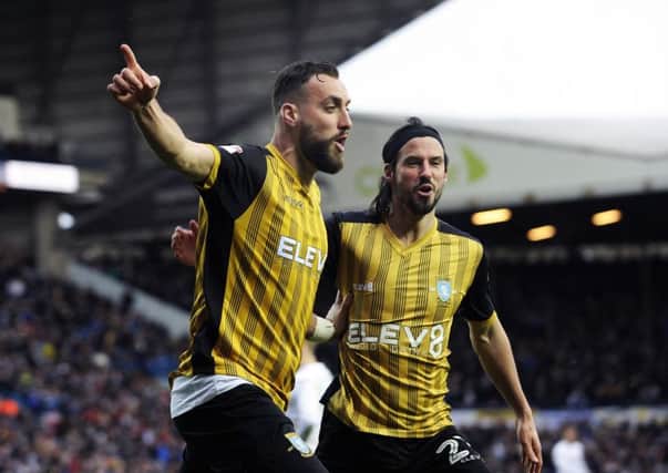 Rescue act: Atdhe Nuhiu, left, reels away in celebration with team-mate George Boyd after his second goal of the afternoon earned Sheffield Wednesday a priceless injury-time win over Leeds United at Elland Road. It was the Owls first League double over their Yorkshire rivals for more than half a century. (Picture: Steve Ellis)