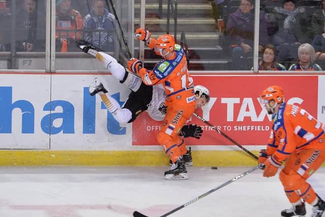 SIDE-ON: Sheffield Steelers' defenceman Davey Phillips puts a hit on a Nottingham Panthers player during Saturday's 3-2 loss on home ice. Picture: Dean Woolley.
