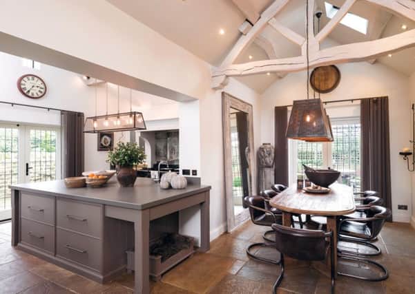 The dining kitchen is a light, bright space thanks to an extension and glazed doors onto the garden.