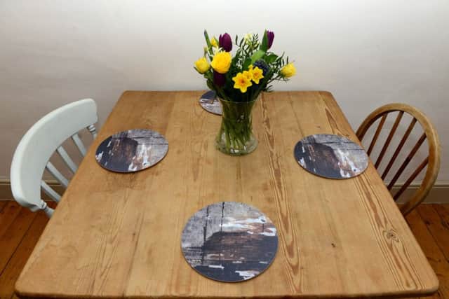 The dining table was a swap with the person who bought her old house and placemats are her own design