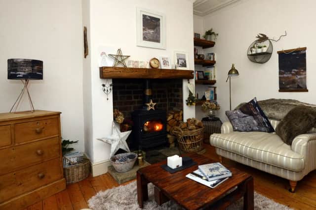 The cosy sitting room with new mantle and shelves. The lampshade, left, and cushions, right, are from Ruth's own range