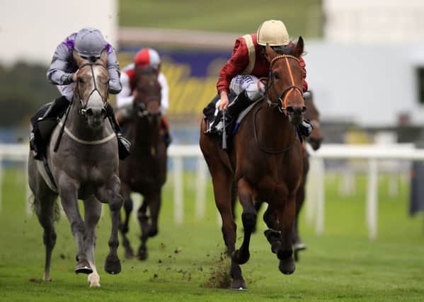 Heartache ridden by Ryan Moore (right) wins The Wainwrights Flying Childers Stakes.