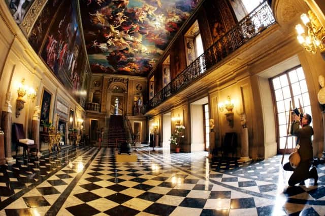 A photographer takes pictures in the Painted Hall