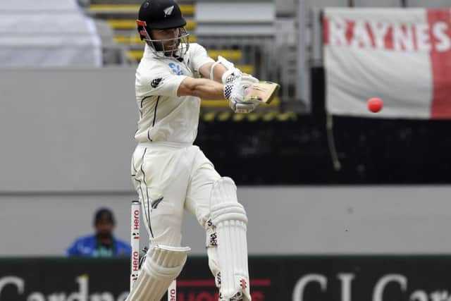 New Zealand's Kane Williamson sweeps against England during their first cricket test in Auckland. (AP Photo/Ross Setford)