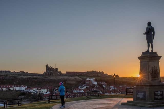 A statue of Captain Cook towers over Whitby harbour