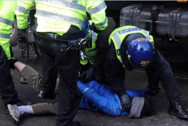 Police arrest a tree campaigner earlier this month.