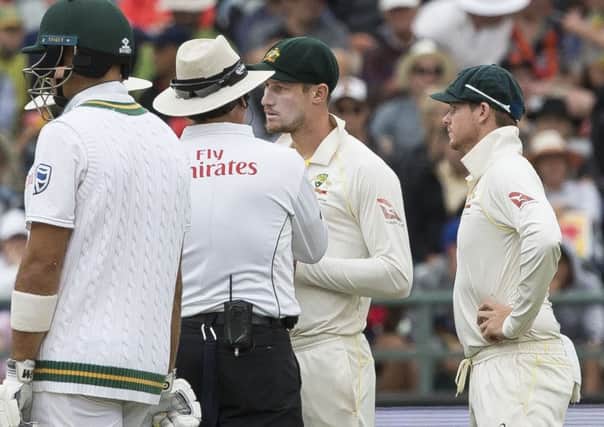 THERE MAY BE TROUBLE AHEAD: Australias Cameron Bancroft talks to the umpire on the third day of the Test match between South Africa and Australia at Newlands, with his captain Steve Smith, right, looking on. Picture: AP.