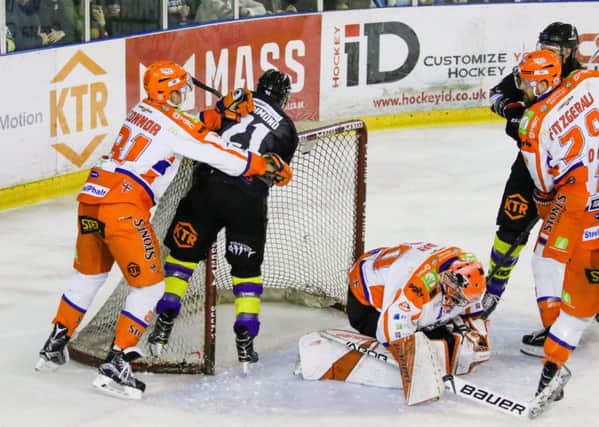 OVER THE TOP: Ben O'Connor, left, tussles with Manchester's Mike Hammond as Steelers' netminder Brad Day covers up. Picture: Mark Ferriss/EIHL.