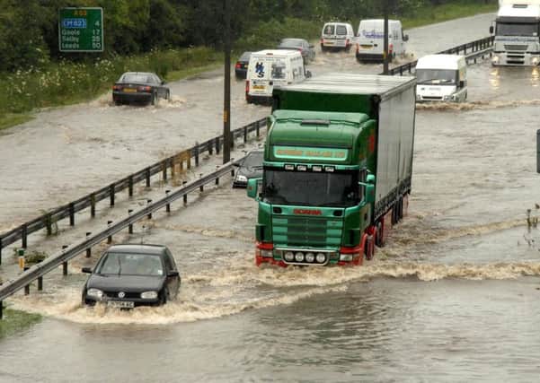 File photo dated 25/06/07 of motorists driving through deep flood water on the A63 road into Hull. Photo credit should read: Anna Gowthorpe/PA Wire