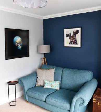 The sitting area with a cow portrait. The skull print matches the colour scheme and was an investment buy from the Art of Protest gallery in York.