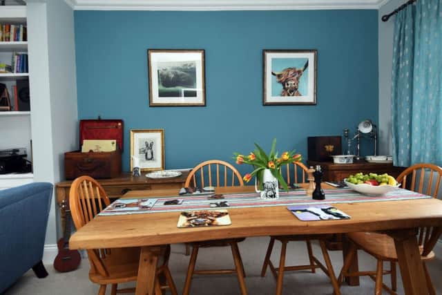 The dining area with one of Lauren's cow portraits on the wall. The table mats are part of her homeware collection.