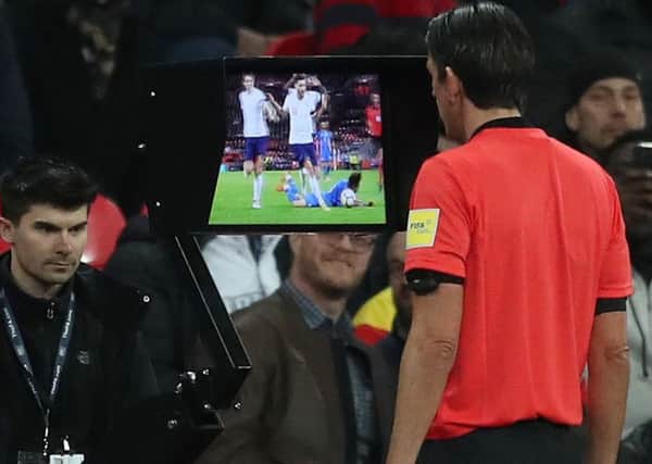Referee Deniz Aytekin consults VAR before awarding Italy a late penalty at Wembley that enabled them to draw 1-1 with England (Picture: Adam Davy/PA Wire).