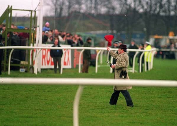 Void: A steward holds up the red flag after a second false start of 1993 Grand National.
