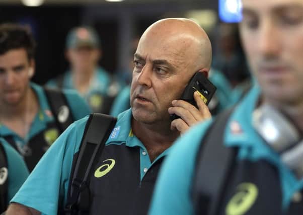 Australia's coach Darren Lehmann talks on the phone,  after the arrival of the Australian team to OR Tambo International International airport in Johannesburg, South Africa. (AP Photo/Themba Hadebe)