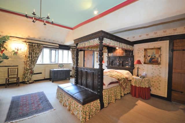 One of the six bedrooms with 17th century-style bed.