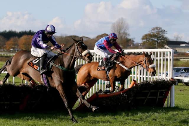 Punchestown-bound La Bague Au Roi, far side, gets the better of Lady Buttons at Wetherby on Charlie Hall Chase day.