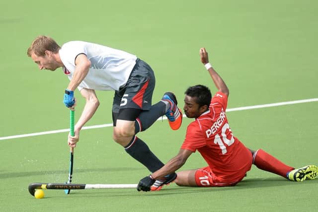 England's Barry Middleton battles for the ball with Canada's Keegan Pereira during the 2014 Commonwealth Games. (Pictures: PA)