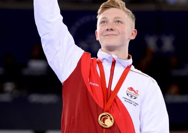 England's Nile Wilson with his gold medal won in the Men's Horizontal Bar Final, at the SSE Hydro, during the 2014 Commonwealth Games in Glasgow.