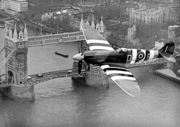 A Spitfire flies over London during the Battle of Britain.