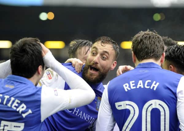Atdhe Nuhiu is surrounded by delighted team-mates after scoring the second of his brace of goals in Sheffield Wednesdays 4-1 home win over Preston North End (Picture: Steve Ellis).
