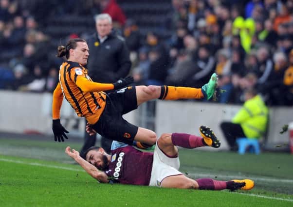 Floored: 
Hull's Jackson Irvine is taken out by former Tigers star Robert Snodgrass. Picture: Tony Johnson