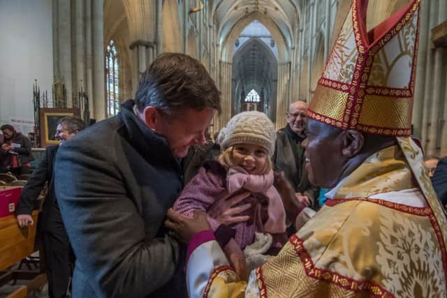 EASTER JOY: The Archbishop of York Dr John Sentamu meets Imogen Drummon, four, with stepfather Stephen Sexton. PIC: James Hardisty