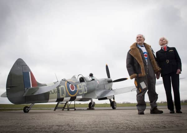 Former Spitfire pilot Squadron Leader Allan Scott, 96, prepares to fly as a passenger in a Spitfire watched by Mary Ellis, 101, the oldest surviving member of the Air Transport Auxiliary wing as part of the RAF100 commemorations at Biggin Hill Airport in Kent. Picture by Stefan Rousseau/PA Wire.