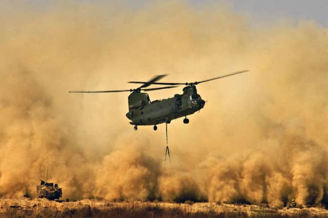 A Royal Air Force CH47 Chinook Helicopter creating a dust storm during the re-supply of the men of 42 Commando Royal Marines at Patrol Base Delhi. Picture by Sean Clee/PA Wire.
