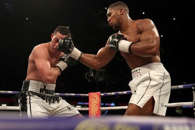 Anthony Joshua (right) catches Joseph Parker full on in the face at the Principality Stadium, Cardiff. Picture: Nick Potts/PA