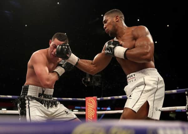 Anthony Joshua (right) catches Joseph Parker full on in the face at the Principality Stadium, Cardiff. Picture: Nick Potts/PA