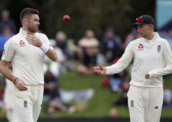 England's Joe Root throws the ball to his bowler James Anderson, left, during play on day four of the second cricket test against New Zealand at Hagley Oval in Christchurch, New Zealand. (AP Photo/Mark Baker)
