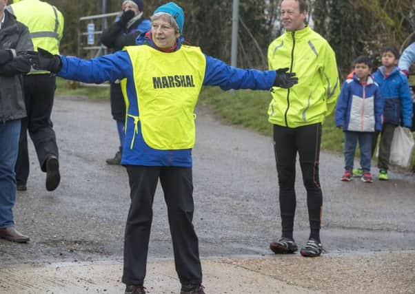 Theresa May acts as a a marshal at a Good Friday fun run in her constituency.