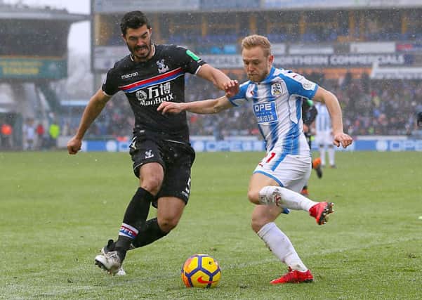 Crystal Palace's James Tomkins (left) and Huddersfield Town's Alex Pritchard battle for the ball in their recent encounter. Picture: Richard Sellers/PA