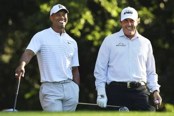 Tiger Woods, left, and Phil Mickelson share a laugh  while playing a practice round for the Masters.