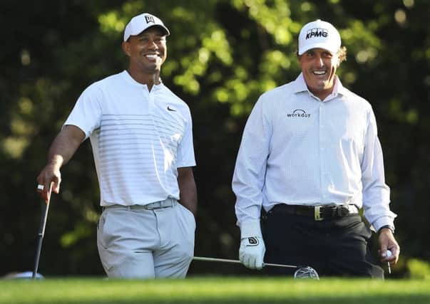 Tiger Woods, left, and Phil Mickelson share a laugh  while playing a practice round for the Masters.