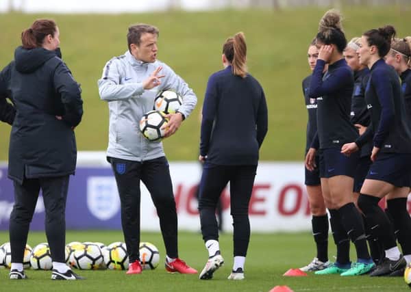 England Women manager Phil Neville (second left) during a training session at St George's Park on Tuesday. Picture: Nigel French/PA