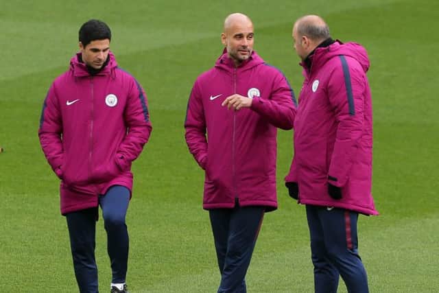 Manchester City manager Pep Guardiola speaks to his coaching staff at Anfield on Tuesday. Picture: Richard Sellers/PA