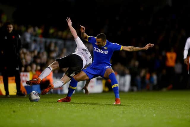 OVER YOU GO: Fulham's Matt Targett is sent flying by Leeds United's Jay-Roy Grot at Craven Cottage on Tuesday night. Picture: James Hardisty.