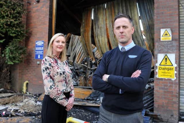 fighting back: Victoria Hopkins and Ben Wilson at the site of MPM which was totally destroyed by fire earlier this year. Picture: tony johnson