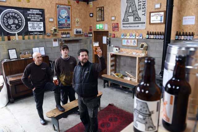 From left, head brewer Andy Capel, second brewer Aidan Burton and Andy Herrington.