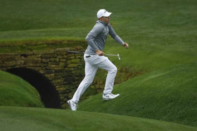 Matthew Fitzpatrick, of England, jumps over Rae's Creek on the 13th hole during a practice round for the Masters golf tournament (AP Photo/Charlie Riedel)
