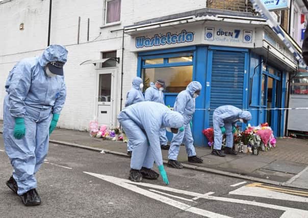 Forensic officers search Chalgrove Road in Tottenham, north London, where a 17-year-old girl has died after she was shot Monday evening.
