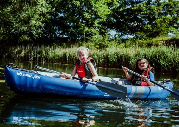 Maisie Lee (left), aged 10, trying out the kayaks on Kingfisher Lakes with glamping guest Stella near Brandesburton.