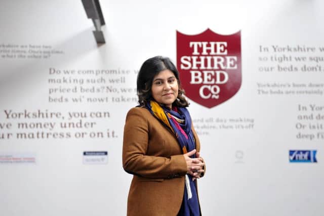 A YORKSHIRE LASS: Baroness Warsi in the showroom at her family's Dewsbury bed factory, in front of the feature wall full of Yorkshire phrases.