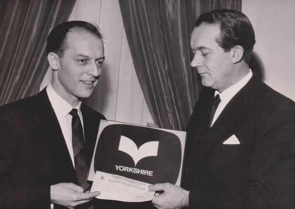 Rex Ripley (left) receiving the prize cheque of Â£370 for his logo design from Yorkshire TV managing director Ward Thomas in 1968