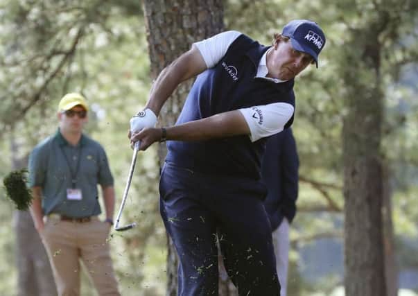Phil Mickelson hits out of the woods off of the first fairway during the second round at Augusta National. Picture: Curtis Compton/AP