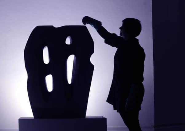 Freelance Conservertor Laura Davies polishes the Hieroglyph by Barbara Hepworth. Picture by Simon Hulme.