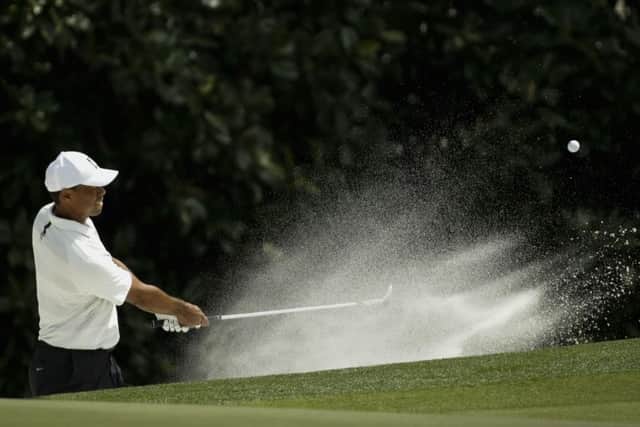 Tiger Woods hits from a bunker on the fifth hole at Augusta on day two. Picture: AP/Chris Carlson